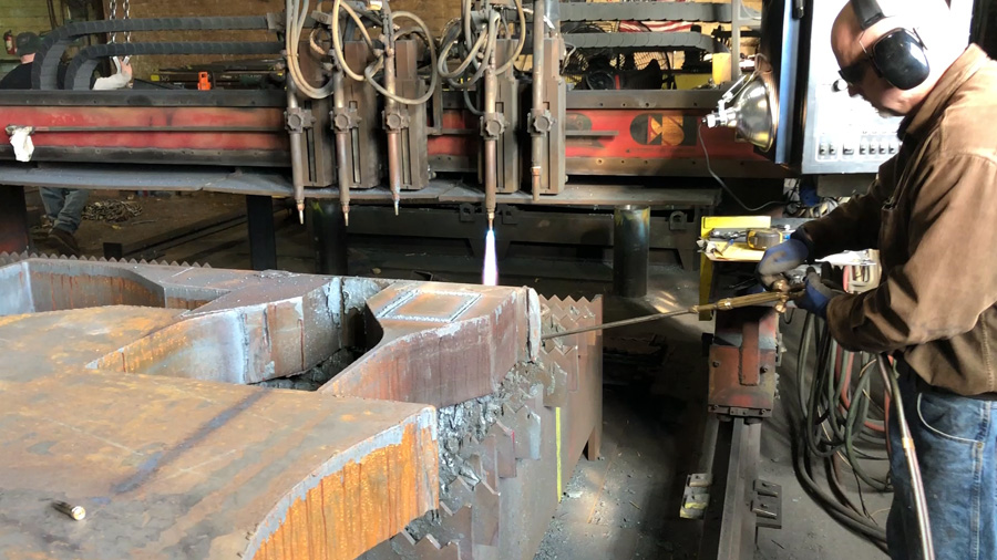 Steel plate processor working on cutting steel Man cutting steel with saw at steel plate supplier in Pennsylvania
