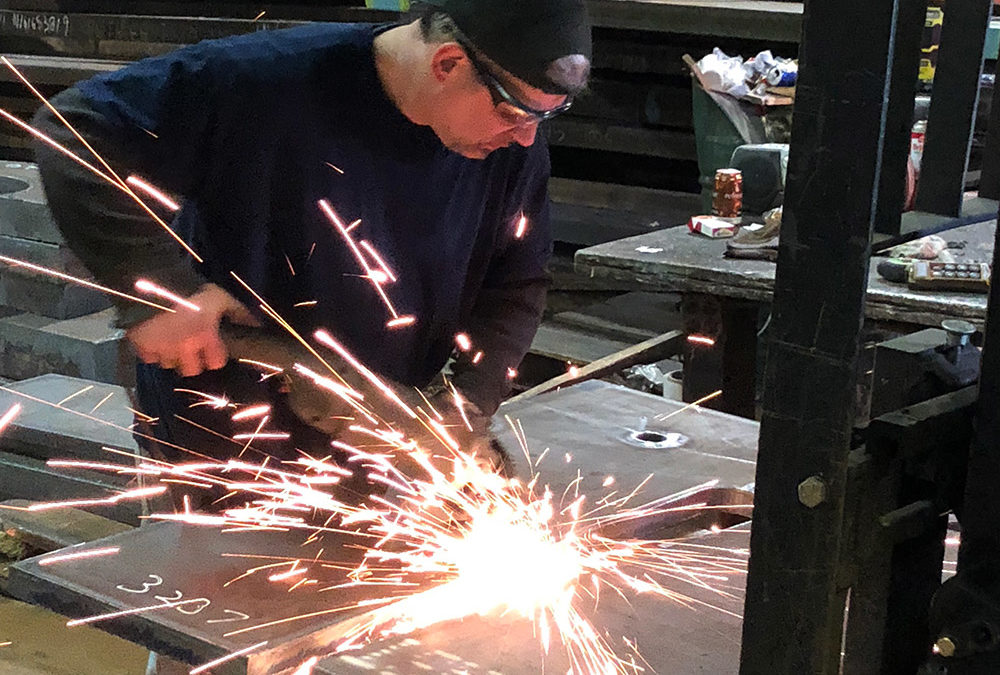 Man working to cut steel at steel plate supplier in Pennsylvania