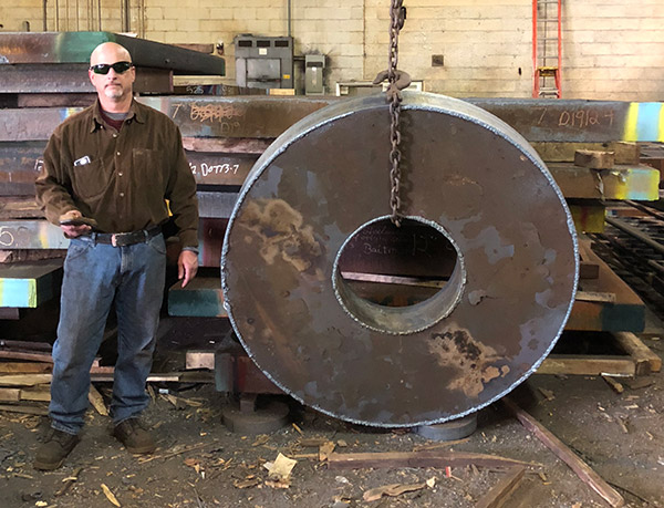 Man working with a steel plate at steel plate supplier in PA