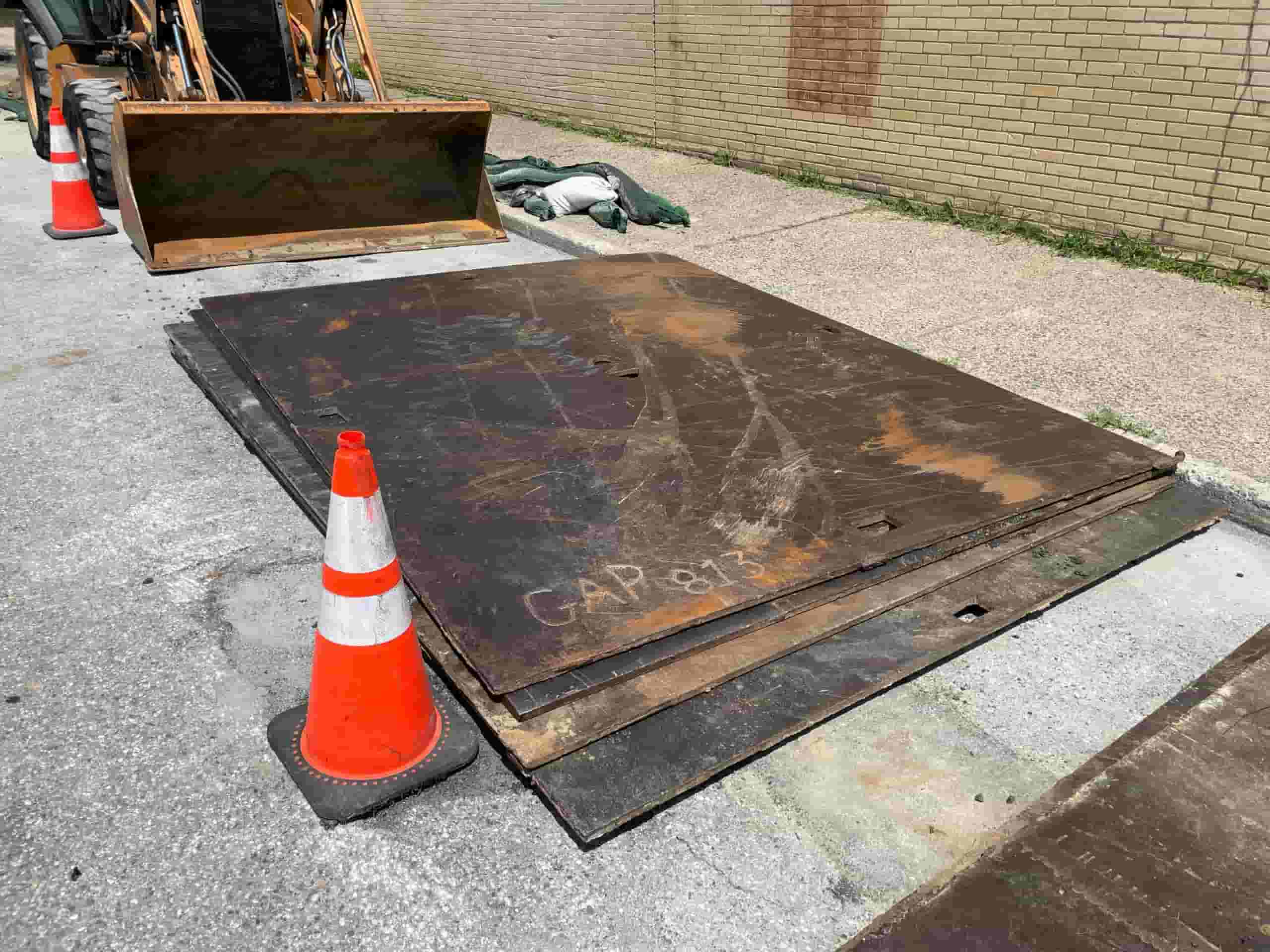 A stack of Delaware Valley Steel road plates stacked on site at a road project.