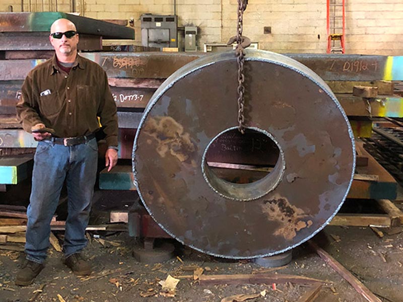 Man working with a steel plate at steel plate supplier in PA